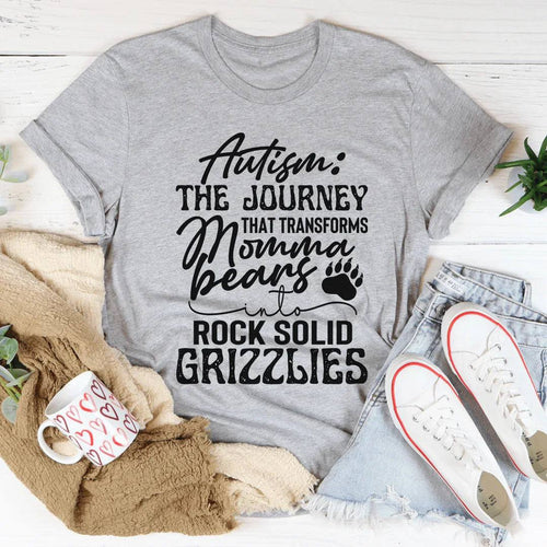 Woman wearing a soft, lightweight Autism Mama Grizzlies Tee styled with jeans and cardigan