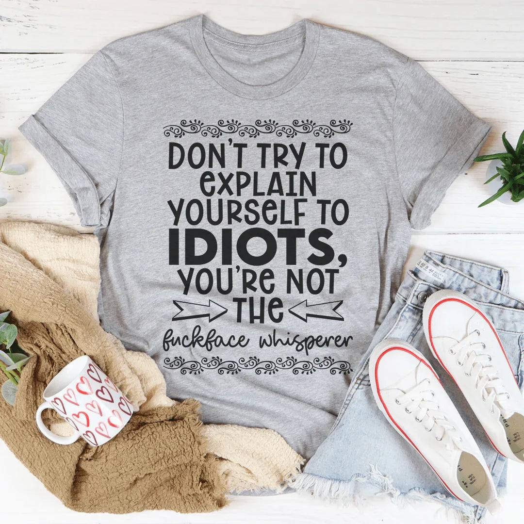 Soft peachy Don't Try To Explain Yourself Tee on white background showing front print design