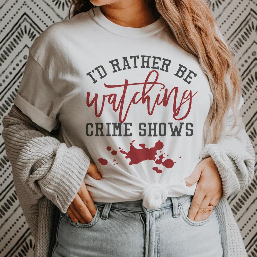 Woman wearing a cozy "I'd Rather Be Watching Crime Shows" tee, perfect for true crime fans and Netflix marathons