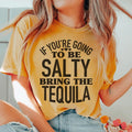 Woman wearing a black Salty Bring The Tequila Tee with white sarcastic text