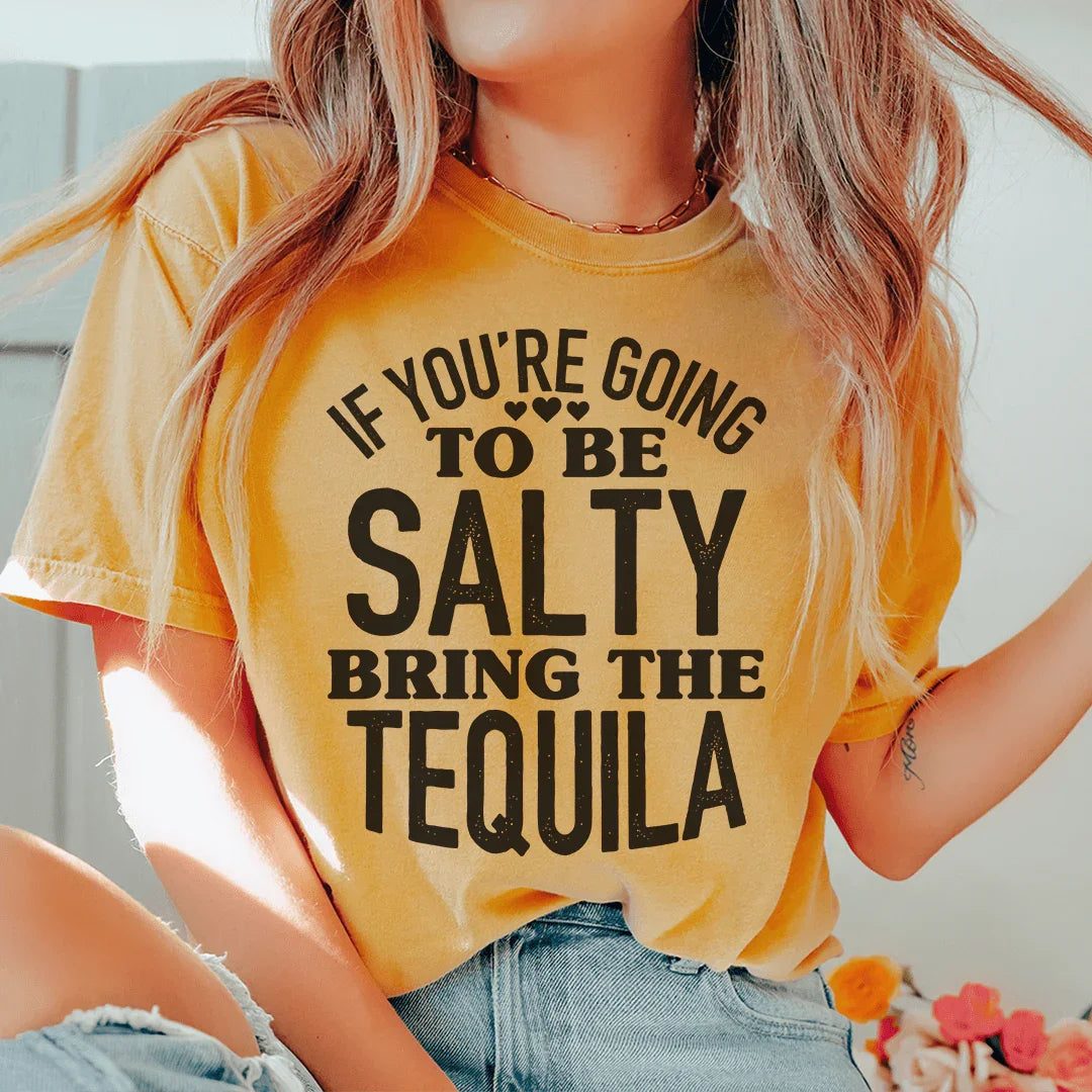 Woman wearing a black Salty Bring The Tequila Tee with white sarcastic text