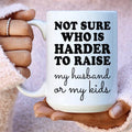 White 15 oz ceramic mug with "Not Sure Who Is Harder To Raise" design, high gloss and durable finish