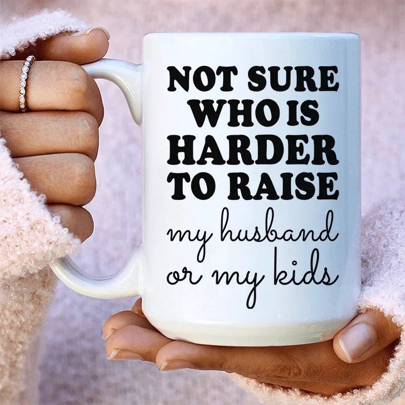 White 15 oz ceramic mug with "Not Sure Who Is Harder To Raise" design, high gloss and durable finish